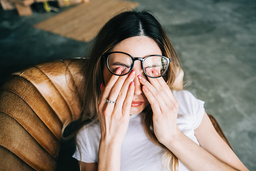 Photo of a woman rubbing her eyes